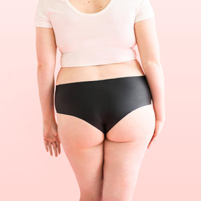 The backside of a woman who is wearing Lorals for Pleasure panties and a white t-shirt |Shortie