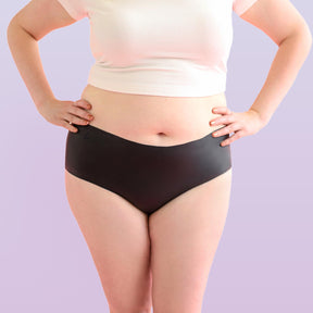 The front side of a woman who is wearing Lorals for STI Protection panties and a white t-shirt |Shortie