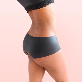 Lorals model Gladys demonstrates the side view of Black Latex Panties in Shortie Style