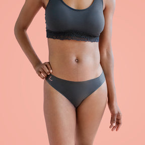 Woman wearing black latex underwear and bra|Bikini