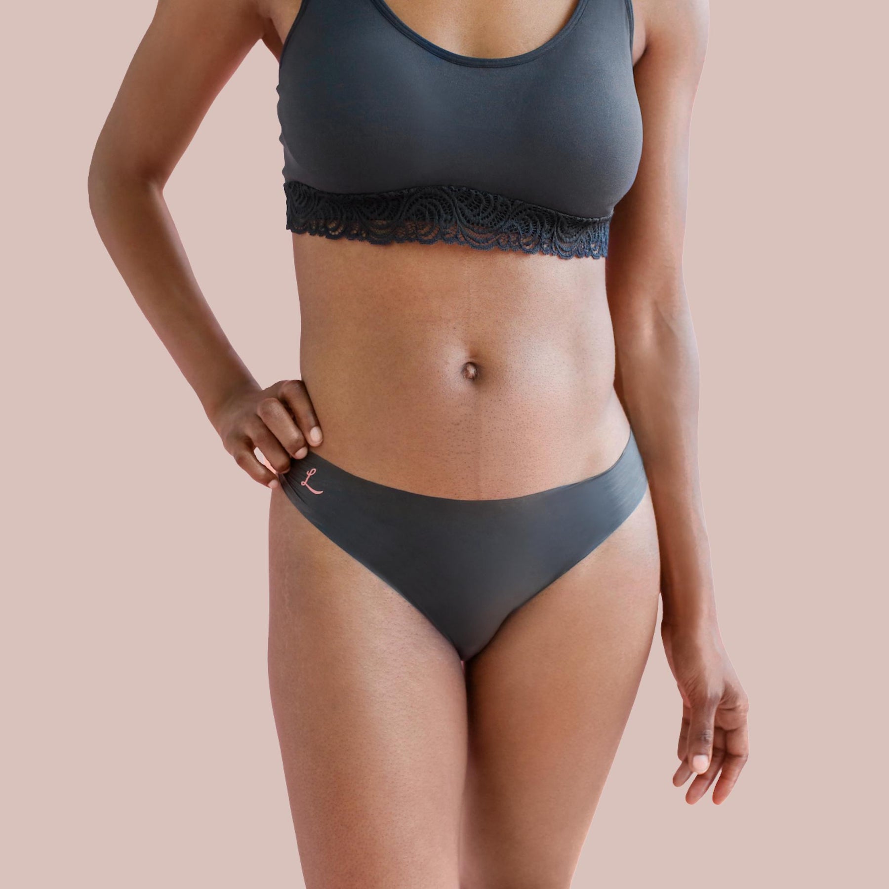 Lorals model Gladys demonstrates the front view of Pleasure Undies in Black Bikinis
