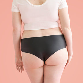 The backside of a woman who is wearing Lorals panties and a white t-shirt |Shortie