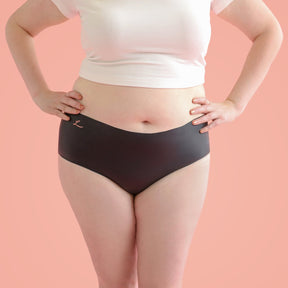 The front side of a woman who is wearing Lorals panties and a white t-shirt |Shortie