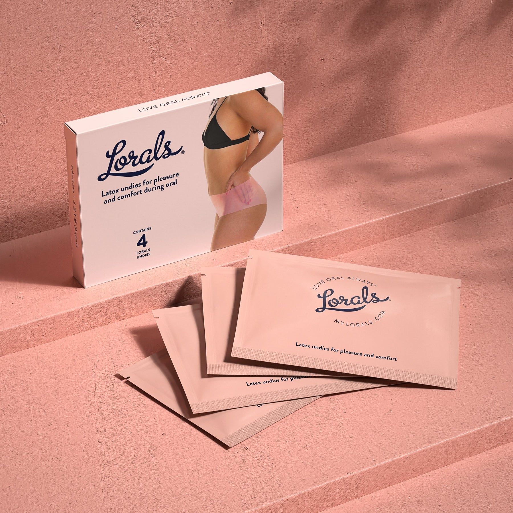 Box and four single-use pouches of Lorals for Pleasure Latex Undies in Sheer